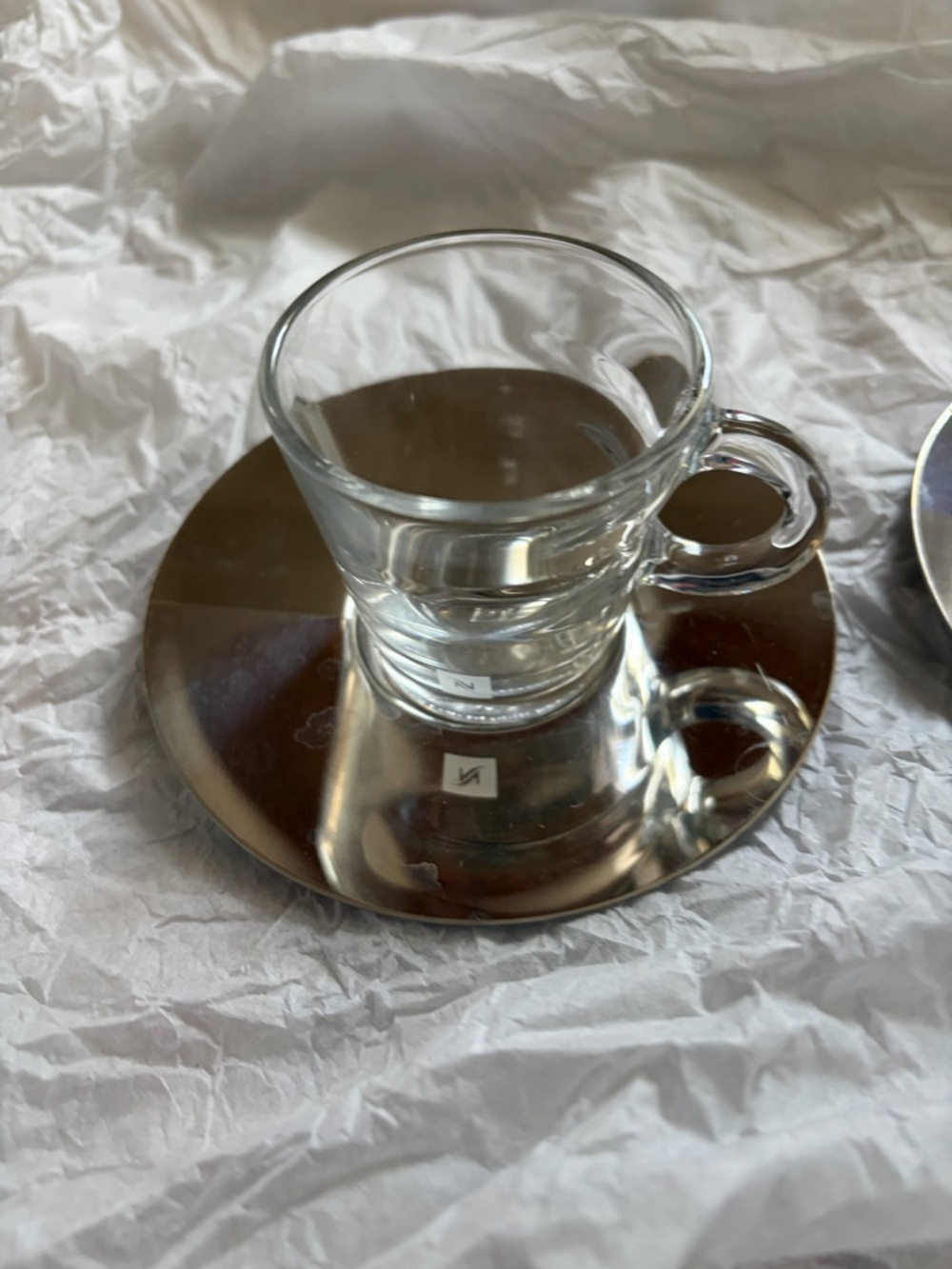 Nespresso View Collection glass espresso cups with stainless saucers.